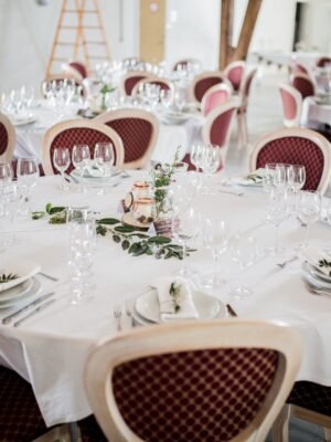 Beautifully arranged dining tables prepared for a formal wedding reception indoors.